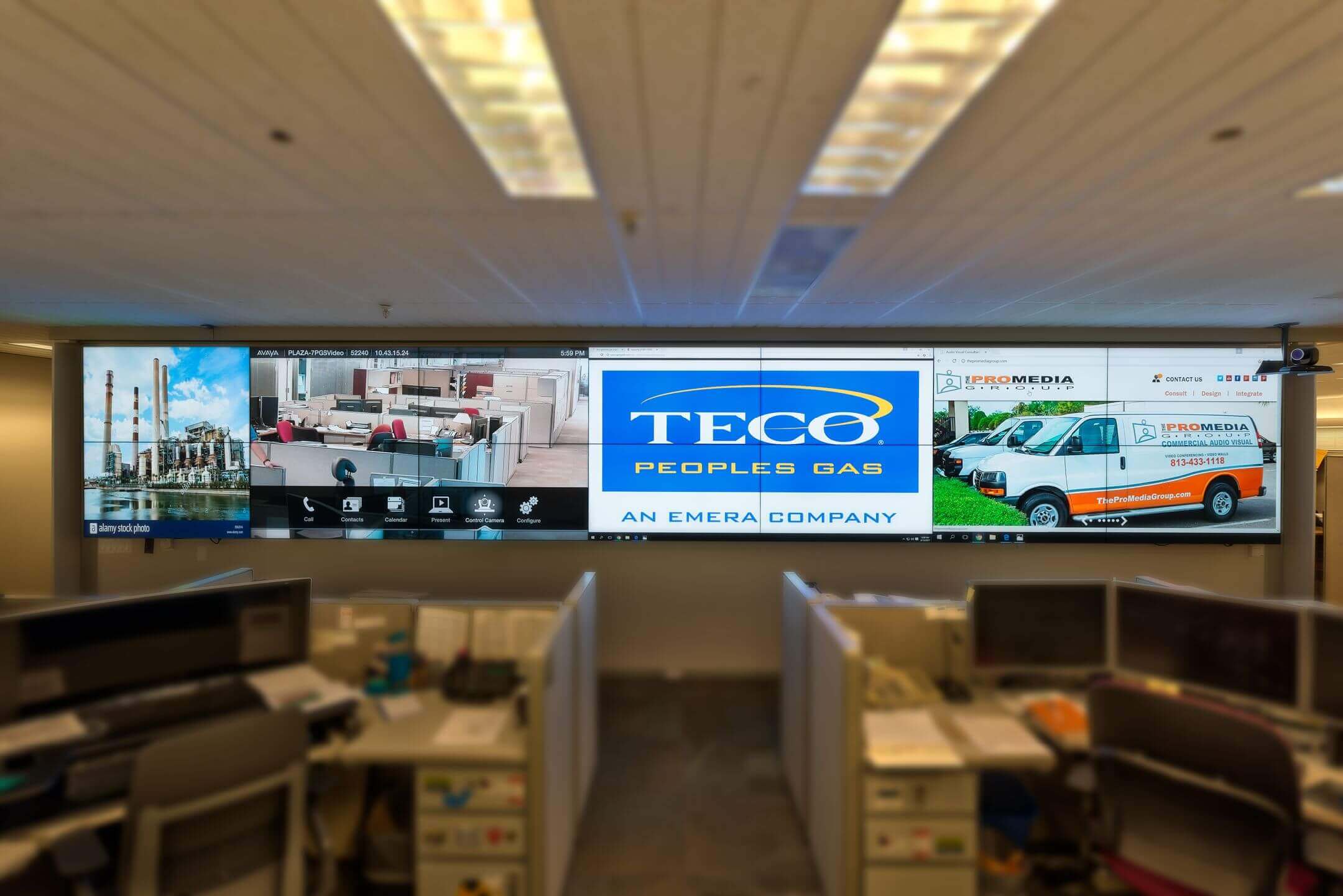 TECO branding displayed on large AV screens at The ProMedia Group event setup.