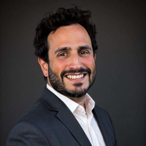 Jesse Decaro Professional man in business suit smiling, headshot for The ProMedia Group.